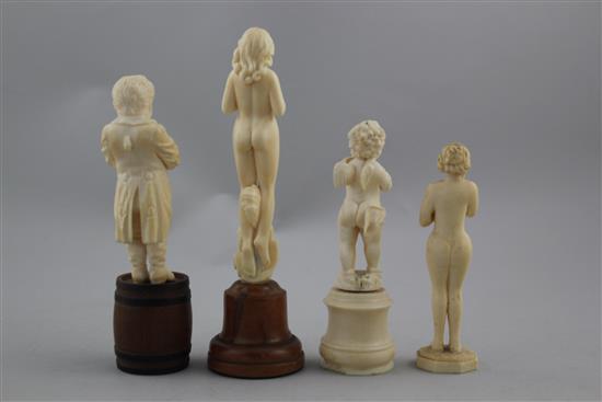 A late 19th century German carved ivory figure standing on a barrel, largest 6.5in. incl. wood plinth